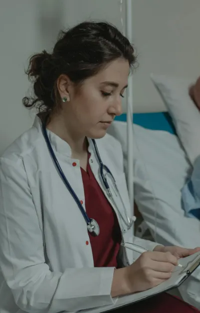 This image shows a doctor writing on the paper.
